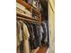 Neatly organized closet with hanging clothes and shelving, offering ample storage space at 7104 Carrondale Way, Las Vegas, NV 89128