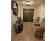 Inviting entryway with decorative console table, tiled floor, and elegant double front doors at 7104 Carrondale Way, Las Vegas, NV 89128