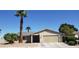 Charming single-story home featuring a well-manicured front yard with mature palm trees and desert landscaping at 7104 Carrondale Way, Las Vegas, NV 89128