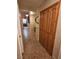 Hallway with tile flooring, wooden storage cabinets, and pendant lights in the distance at 7104 Carrondale Way, Las Vegas, NV 89128