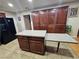 Spacious kitchen with a central island featuring counter seating, tiled floor and abundant storage at 7104 Carrondale Way, Las Vegas, NV 89128