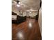 Expansive primary bedroom with hardwood floors, ceiling fans, and abundant space for a sitting area at 7104 Carrondale Way, Las Vegas, NV 89128