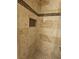 Elegant walk-in shower features decorative tile and a built-in shelf niche at 7104 Carrondale Way, Las Vegas, NV 89128