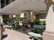 Outdoor BBQ area featuring built in grills and green picnic tables at 7147 S Durango Dr # 211, Las Vegas, NV 89113