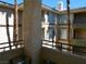 A relaxing balcony offers courtyard views with palm trees and building facade at 7147 S Durango Dr # 211, Las Vegas, NV 89113