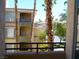 This balcony overlooks palm trees and other units of the home's complex at 7147 S Durango Dr # 211, Las Vegas, NV 89113