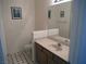 Cozy bathroom with a single sink vanity and black and white tiled floor at 7147 S Durango Dr # 211, Las Vegas, NV 89113