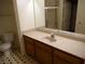 Neutral bathroom features a wooden vanity and shower with glass doors at 7147 S Durango Dr # 211, Las Vegas, NV 89113