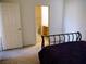 Bedroom with a bed, door to the hallway and partial view of the bathroom at 7147 S Durango Dr # 211, Las Vegas, NV 89113