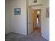 A bedroom with neutral walls, carpet, and an open doorway to the kitchen and other rooms at 7147 S Durango Dr # 211, Las Vegas, NV 89113