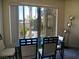 Well-lit dining area with a glass-top table and seating, offering views of the neighborhood at 7147 S Durango Dr # 211, Las Vegas, NV 89113