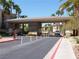 Community gate entrance with covered security checkpoint and landscaping, providing privacy and security for residents at 7147 S Durango Dr # 211, Las Vegas, NV 89113