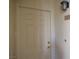 A clean, white front door with classic paneling and modern hardware on a light-colored exterior wall at 7147 S Durango Dr # 211, Las Vegas, NV 89113