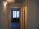 Hallway view leading to a room with a desk and window, lit by natural light at 7147 S Durango Dr # 211, Las Vegas, NV 89113
