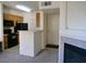 Functional kitchen with black appliances, oak cabinets, and tiled flooring, open to other living spaces at 7147 S Durango Dr # 211, Las Vegas, NV 89113