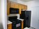 Functional kitchen features modern black appliances including a gas range, microwave, and refrigerator at 7147 S Durango Dr # 211, Las Vegas, NV 89113