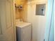 Convenient laundry room area with white appliances and storage shelving at 7147 S Durango Dr # 211, Las Vegas, NV 89113
