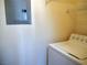 Bright laundry area featuring a top-load washer and gray electrical panel at 7147 S Durango Dr # 211, Las Vegas, NV 89113
