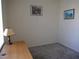 A simple home office with desk, carpet, and a large window for natural light at 7147 S Durango Dr # 211, Las Vegas, NV 89113