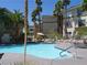 Community pool with palm trees and lounge chairs, perfect for enjoying sunny days in a tranquil setting at 7147 S Durango Dr # 211, Las Vegas, NV 89113