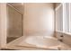 Bathroom with a separate glass-enclosed shower and a soaking tub at 7620 Tortola Bay Ln, Las Vegas, NV 89128