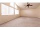 Spacious bedroom with vaulted ceiling, a ceiling fan and large windows at 7620 Tortola Bay Ln, Las Vegas, NV 89128