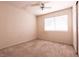 Neutral bedroom with a ceiling fan, window, and carpet at 7620 Tortola Bay Ln, Las Vegas, NV 89128