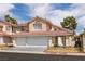 Charming home featuring a red tile roof, a two-car garage, and well maintained landscaping at 7620 Tortola Bay Ln, Las Vegas, NV 89128