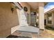 A covered front porch and door, plus an exterior light fixture at 7620 Tortola Bay Ln, Las Vegas, NV 89128