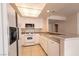 Well-lit kitchen featuring white cabinets and modern appliances at 7620 Tortola Bay Ln, Las Vegas, NV 89128