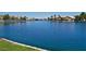 Relaxing view of lake featuring calm waters surrounded by beautiful lakeside homes and lush vegetation at 7620 Tortola Bay Ln, Las Vegas, NV 89128
