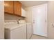 Dedicated laundry room with washer, dryer, and storage cabinets at 7620 Tortola Bay Ln, Las Vegas, NV 89128