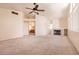 Open-concept living room with vaulted ceiling, fireplace, and neutral carpet at 7620 Tortola Bay Ln, Las Vegas, NV 89128