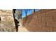 Block wall with a backyard metal gate and desert landscaping at 8768 Charm Canyon Ave, Las Vegas, NV 89178