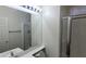 Bright bathroom featuring a glass shower stall, a large mirror, and a sleek vanity with modern fixtures at 8768 Charm Canyon Ave, Las Vegas, NV 89178