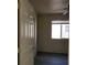 Cozy bedroom featuring a ceiling fan, window with blinds, and dark laminate flooring at 8768 Charm Canyon Ave, Las Vegas, NV 89178