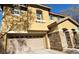 Exterior of a two story home with two-car garage and a stone pillar accent at 8768 Charm Canyon Ave, Las Vegas, NV 89178