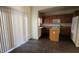 A spacious dining area and kitchen with tiled flooring, natural light from a sliding glass door, and modern appliances at 8768 Charm Canyon Ave, Las Vegas, NV 89178