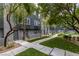 Community featuring townhouses with green turf, palm trees, and walkways at 9050 W Tropicana Ave # 1053, Las Vegas, NV 89147