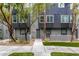 Well-maintained townhouse exterior with green turf, trees, and neutral paint scheme at 9050 W Tropicana Ave # 1053, Las Vegas, NV 89147