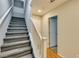 Hallway with a carpeted staircase and hardwood floors leading to the next level at 9050 W Tropicana Ave # 1053, Las Vegas, NV 89147