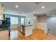 Open kitchen with stainless steel appliances, island, and wood-look flooring at 9050 W Tropicana Ave # 1053, Las Vegas, NV 89147
