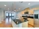 Modern kitchen featuring stainless steel appliances, a black countertop island, and light wood cabinetry at 9050 W Tropicana Ave # 1053, Las Vegas, NV 89147