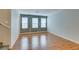Living area with hardwood floors and natural light from three windows at 9050 W Tropicana Ave # 1053, Las Vegas, NV 89147