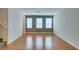 Large living room with vinyl wood flooring, neutral paint, and many windows for natural light at 9050 W Tropicana Ave # 1053, Las Vegas, NV 89147