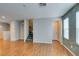 Open-concept living area with wood-look floors, stairs, and lots of natural light at 9050 W Tropicana Ave # 1053, Las Vegas, NV 89147