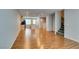 View of the open floor plan living room into kitchen and stairwell, featuring wood flooring and recessed lighting at 9050 W Tropicana Ave # 1053, Las Vegas, NV 89147