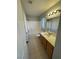 Bright bathroom featuring a tub and shower combination with a light-wood vanity and neutral tile floors at 9641 Windborne Ave, Las Vegas, NV 89147