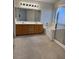 Primary bathroom featuring a tub, glass shower door, and a double sink vanity at 9641 Windborne Ave, Las Vegas, NV 89147