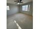 Bedroom with ceiling fan, carpet, and bright windows at 9641 Windborne Ave, Las Vegas, NV 89147